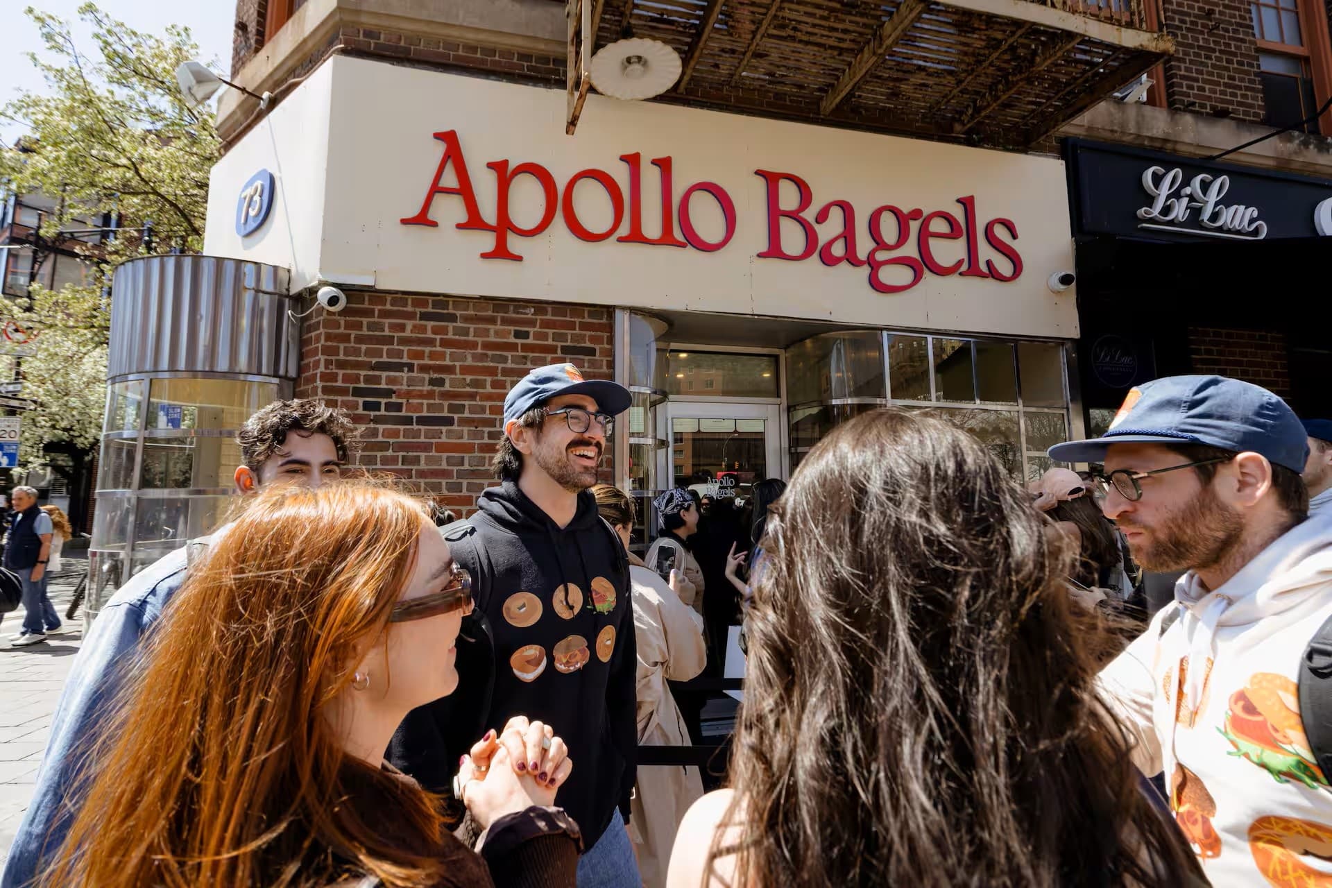 Group on NYC bagel walking tour at Apollo Bagels storefront