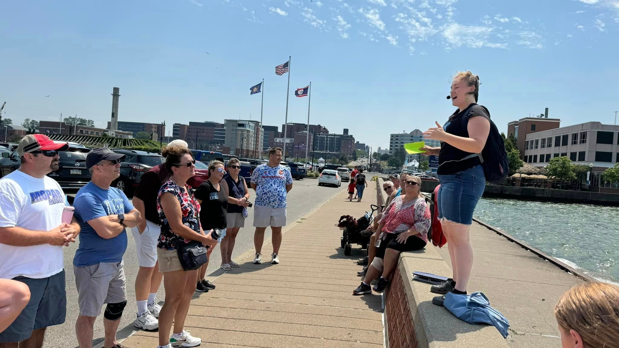 Guide leading waterfront walking tour along Erie Harbor