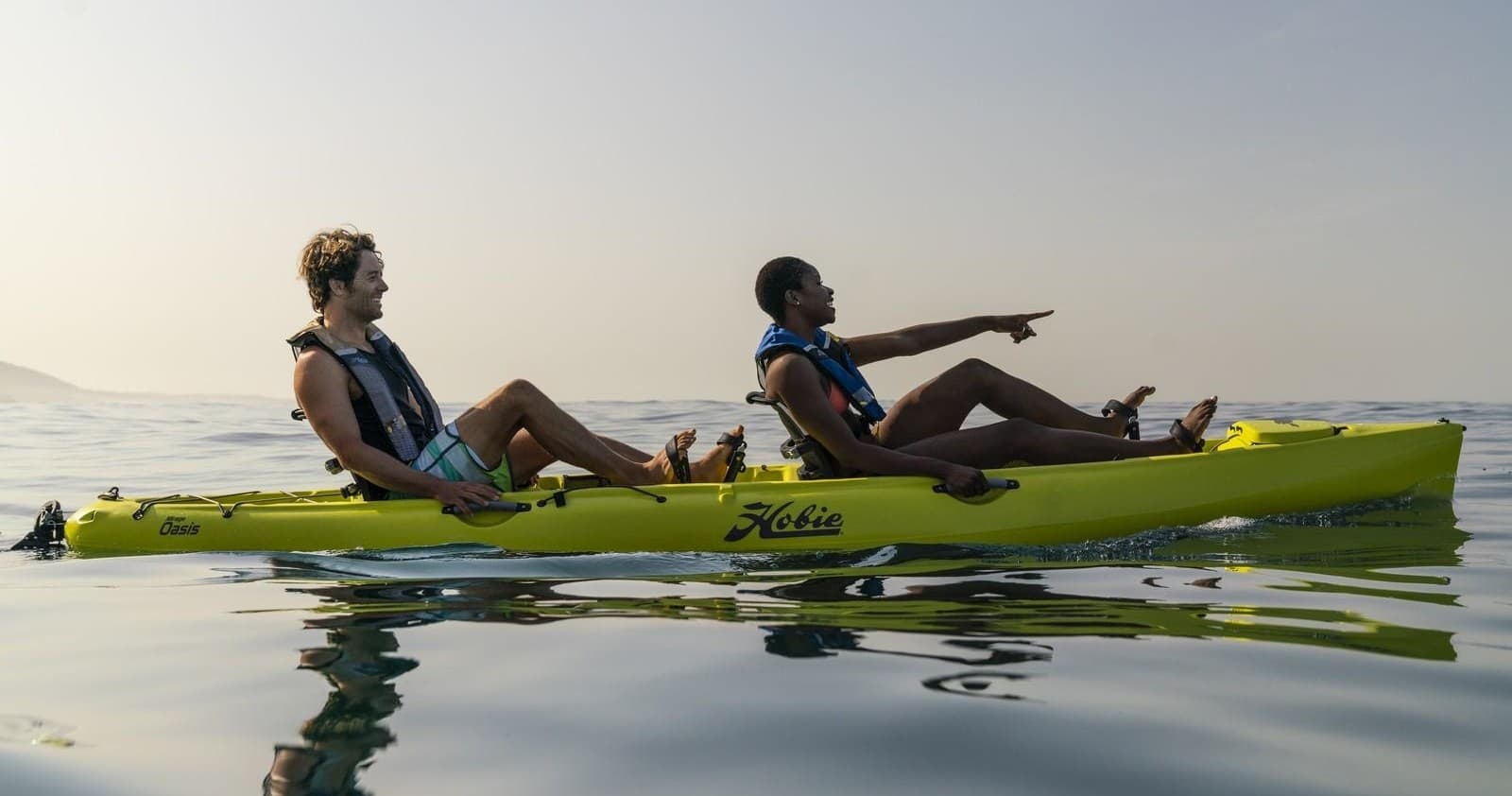 Tandem kayak with two paddlers exploring calm open sea