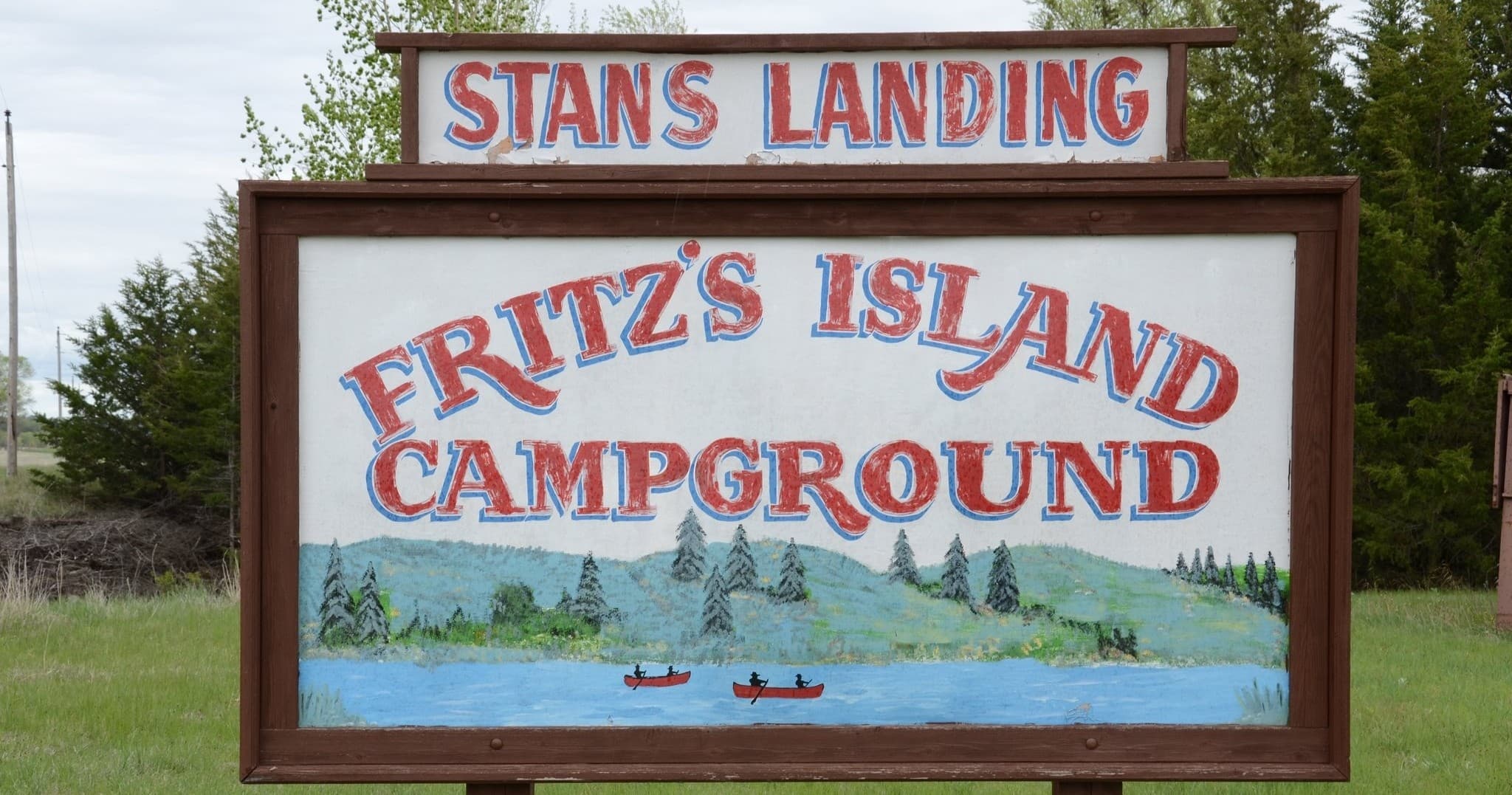 Painted campground sign for Fritz's Island at boat landing