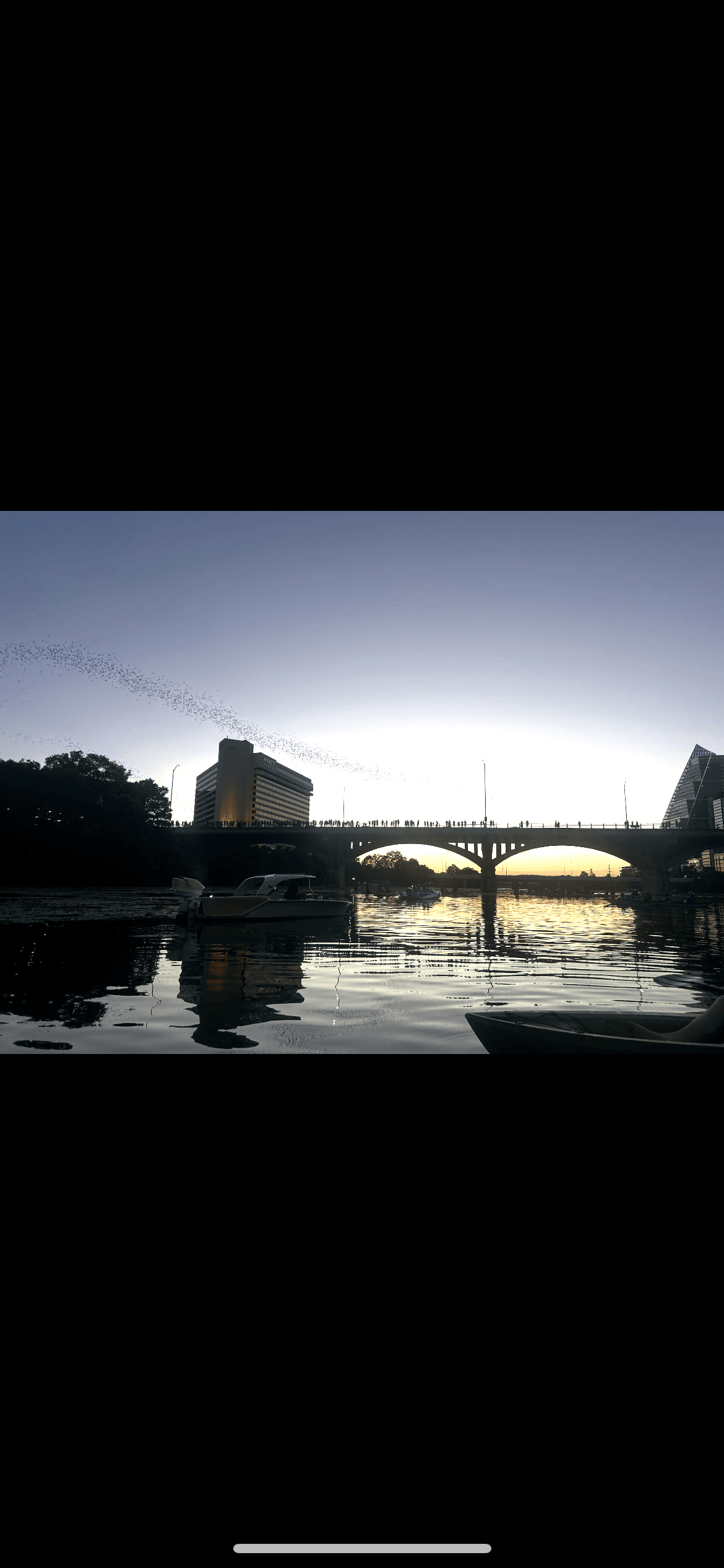 Bridge reflection at dusk over river, limited vertical crop