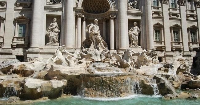 Tourists at Trevi Fountain ornate sculptures and water