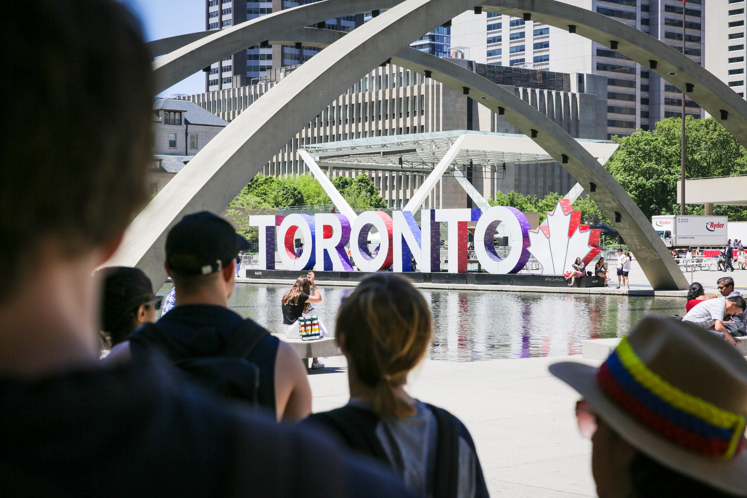 Crowd in front of iconic Toronto sign at Nathan Phillips Square