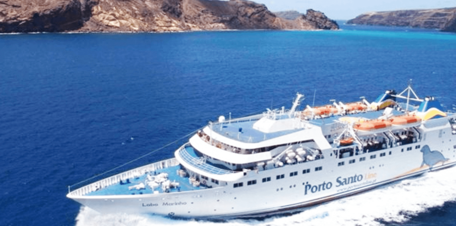 Cruise ship sailing near rugged coastline, sea excursion