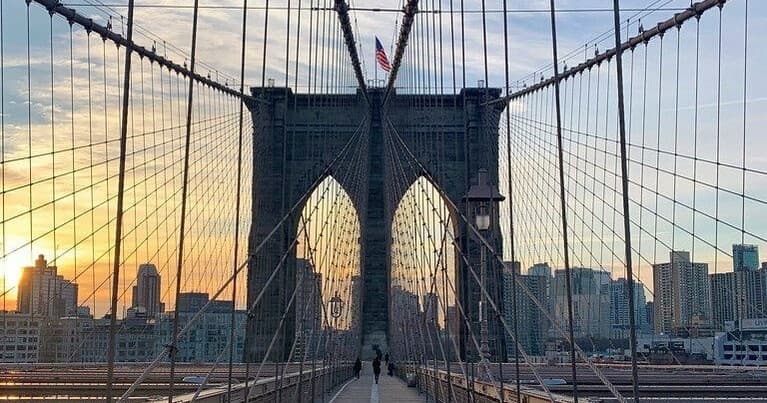 Brooklyn Bridge sunrise with Manhattan skyline waterfront view