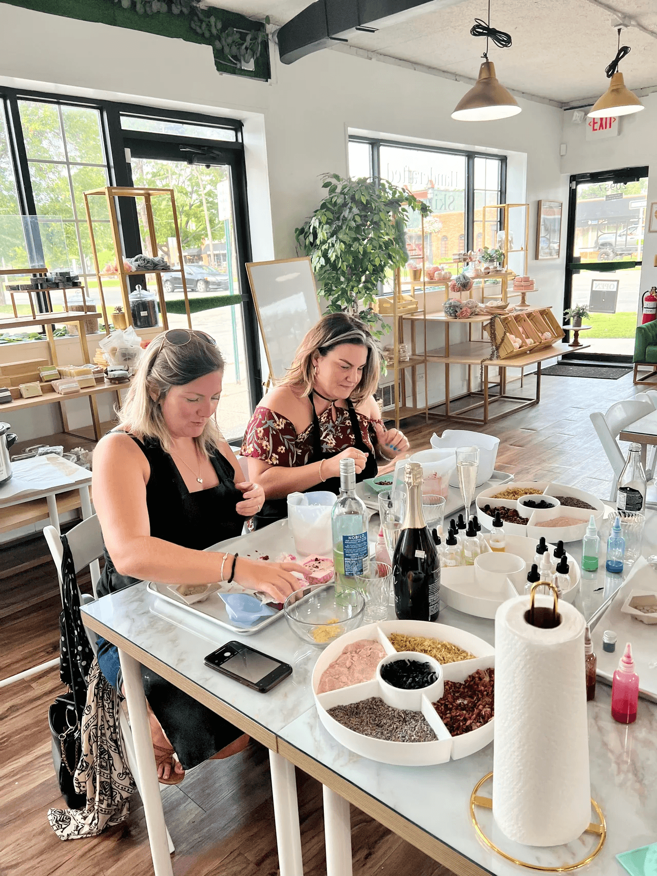 Small-group soapmaking workshop in sunny studio with plants