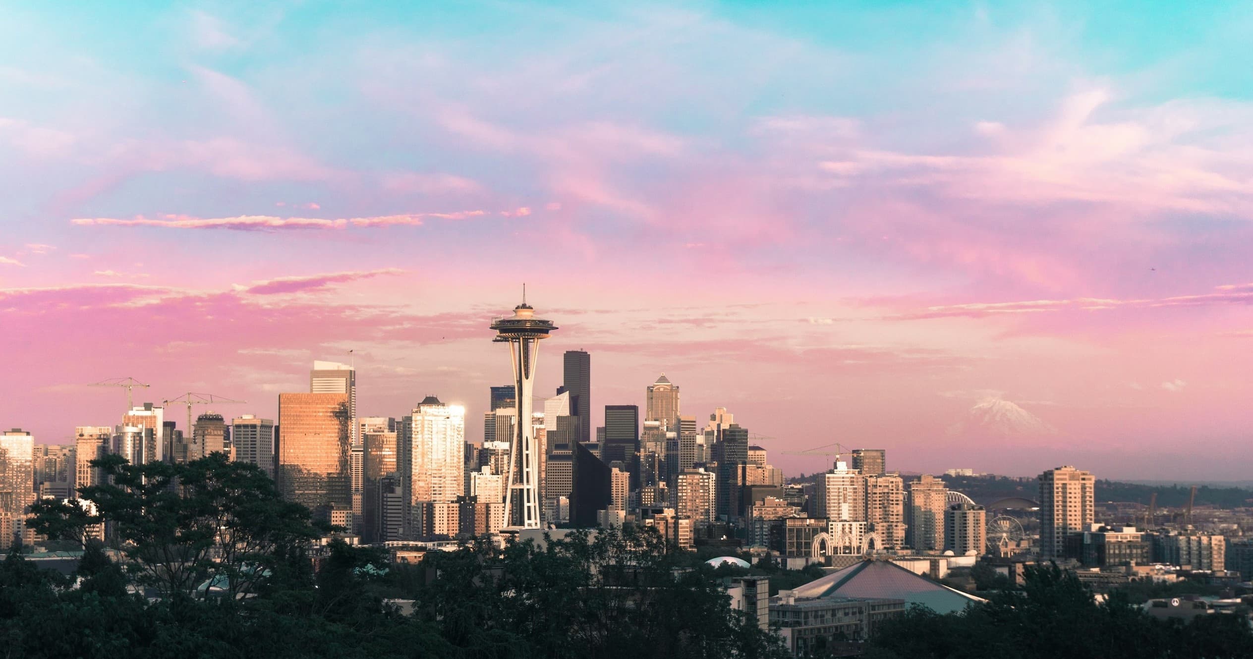 Seattle skyline at pink sunset over Elliott Bay, city panorama