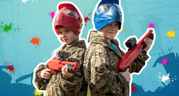 Kids in camo holding toy blasters at colorful outdoor arena