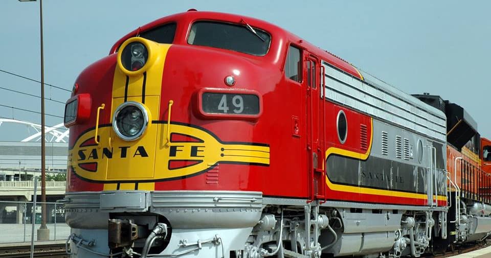 Red Santa Fe diesel locomotive at station, outdoor rail exhibition display