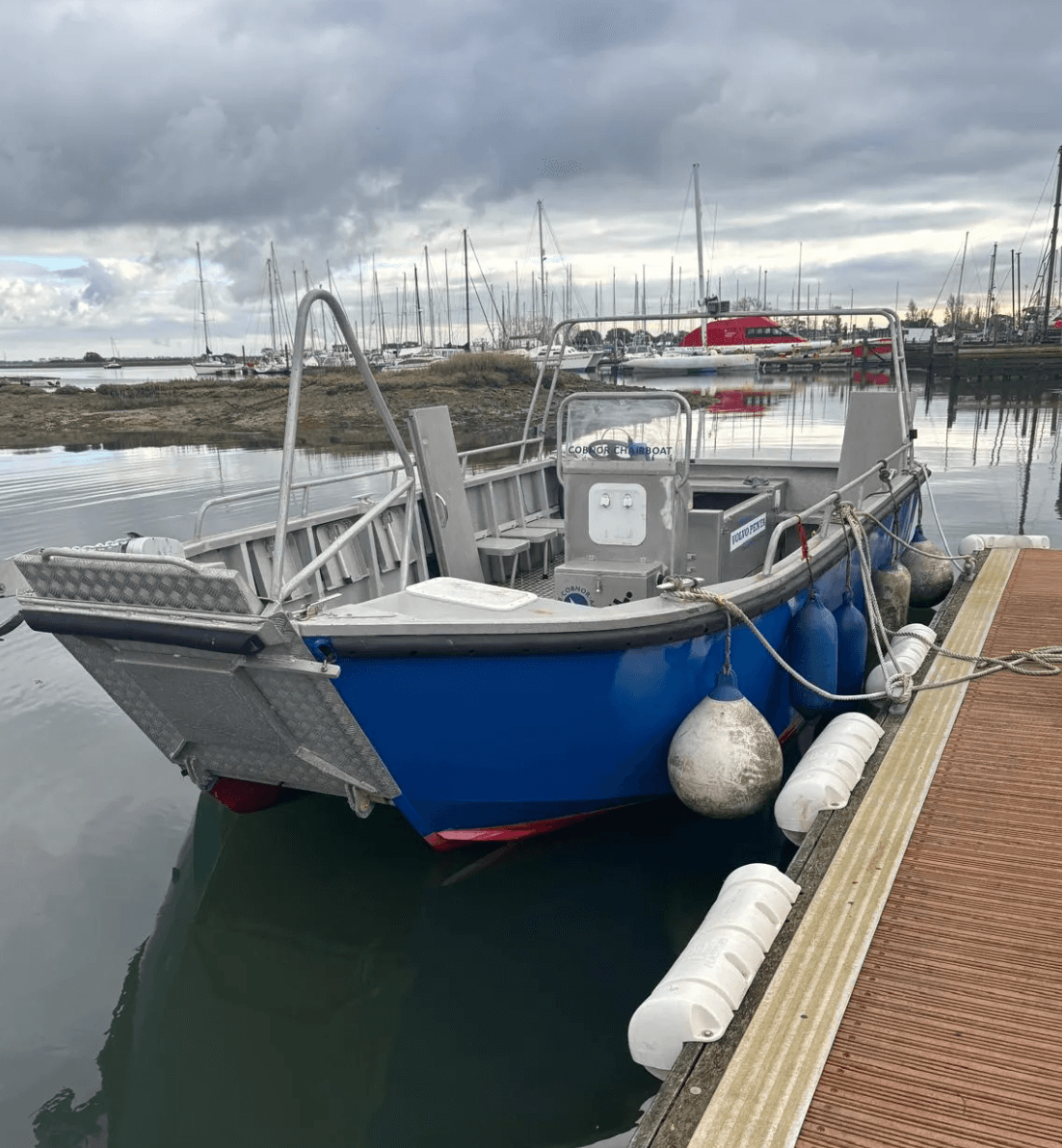 Small charter boat moored at Chichester Harbour marina dock