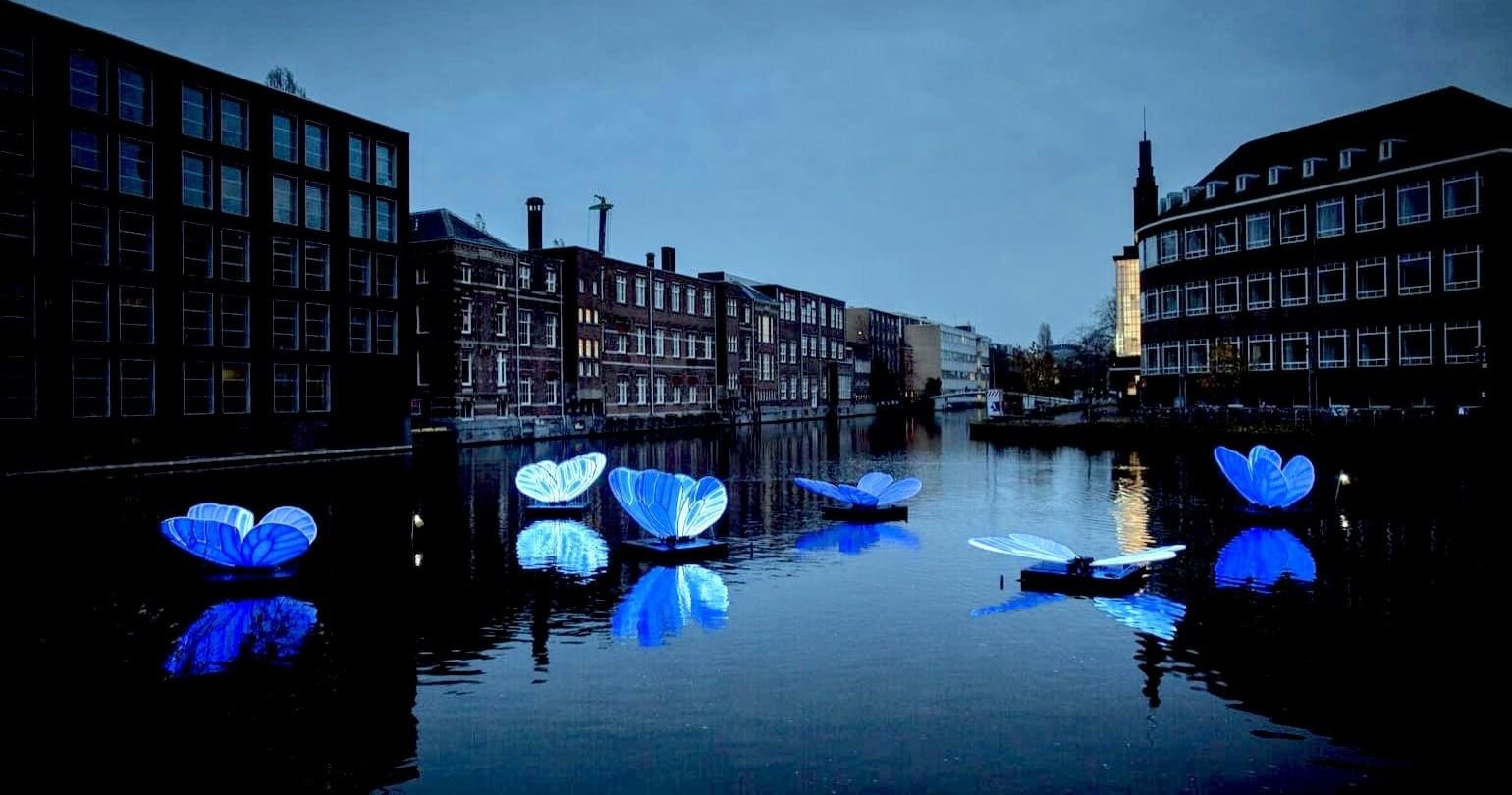 Evening canal lights and reflections on Amsterdam waterway