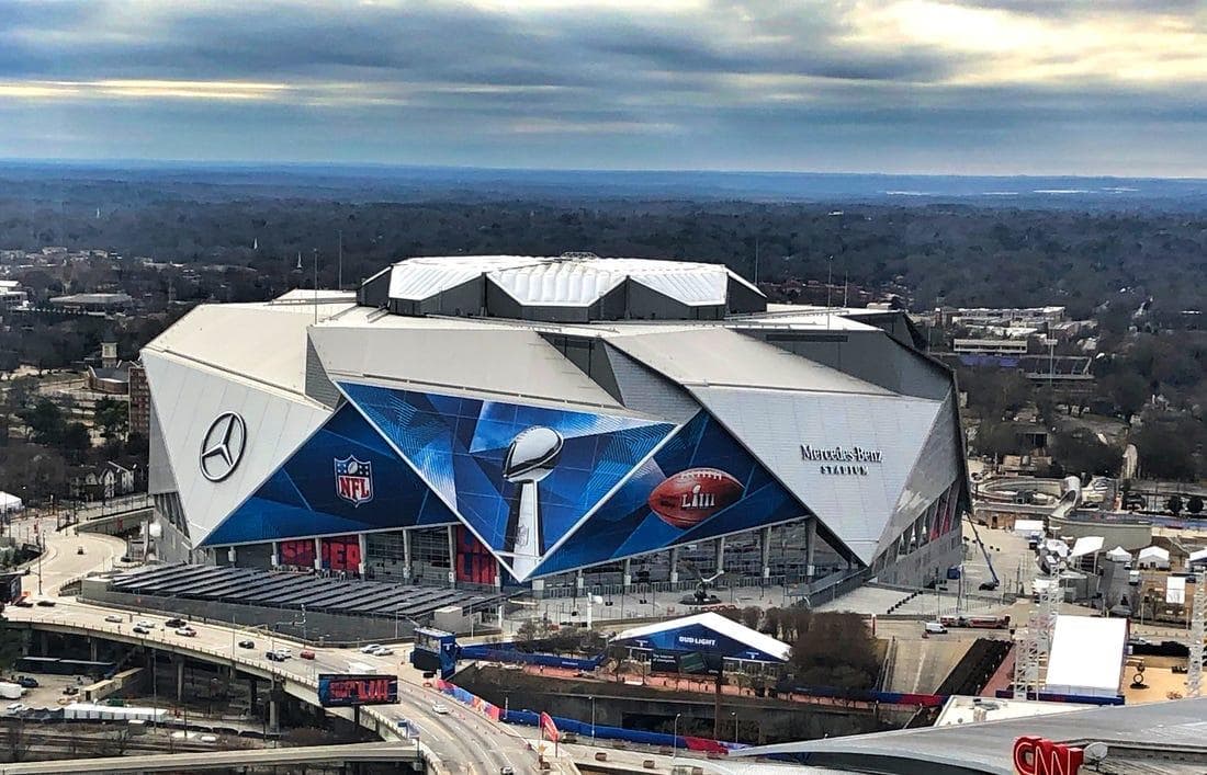 Aerial view of modern stadium and surrounding urban landscape