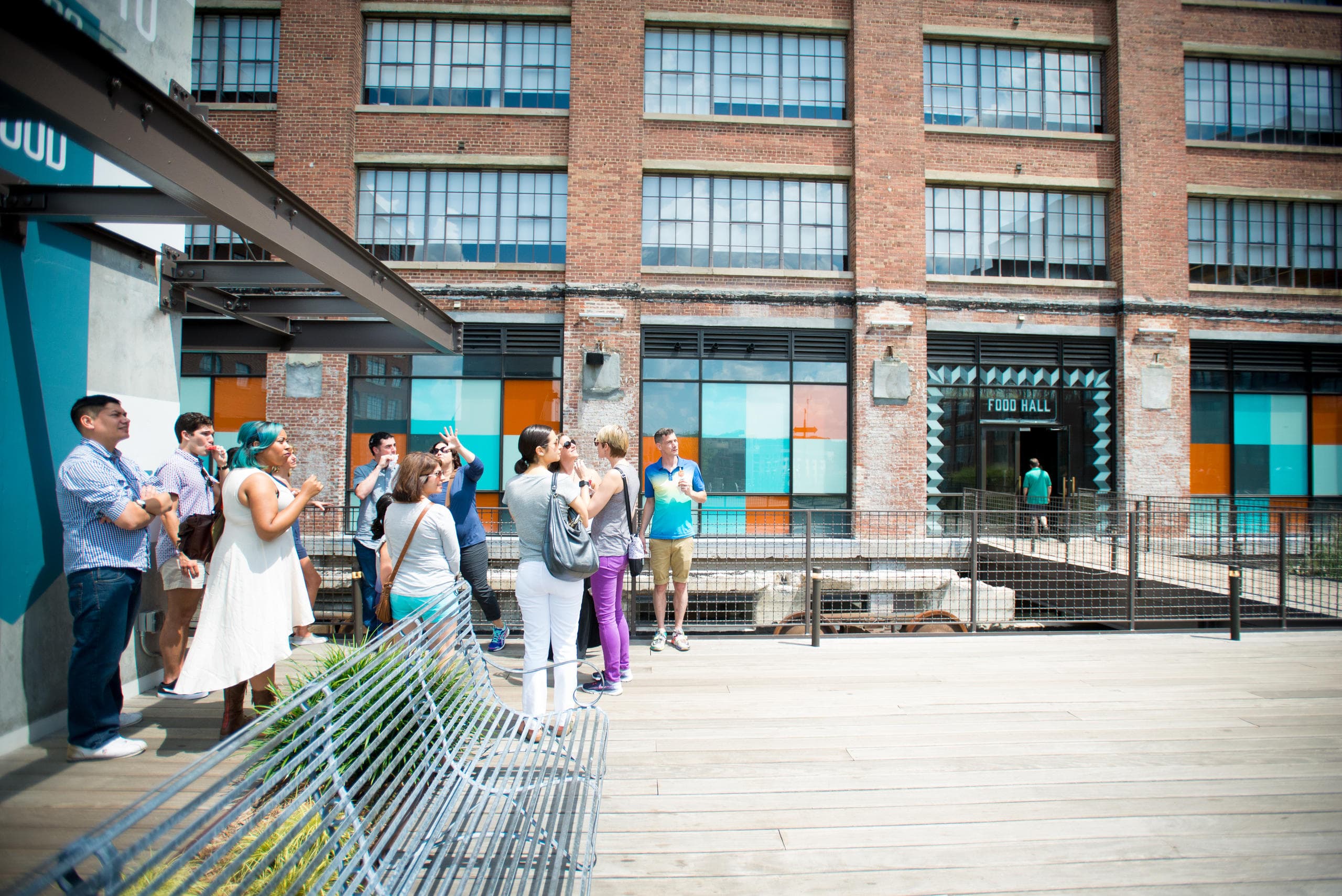 Food tour group walking along industrial Atlanta market promenade