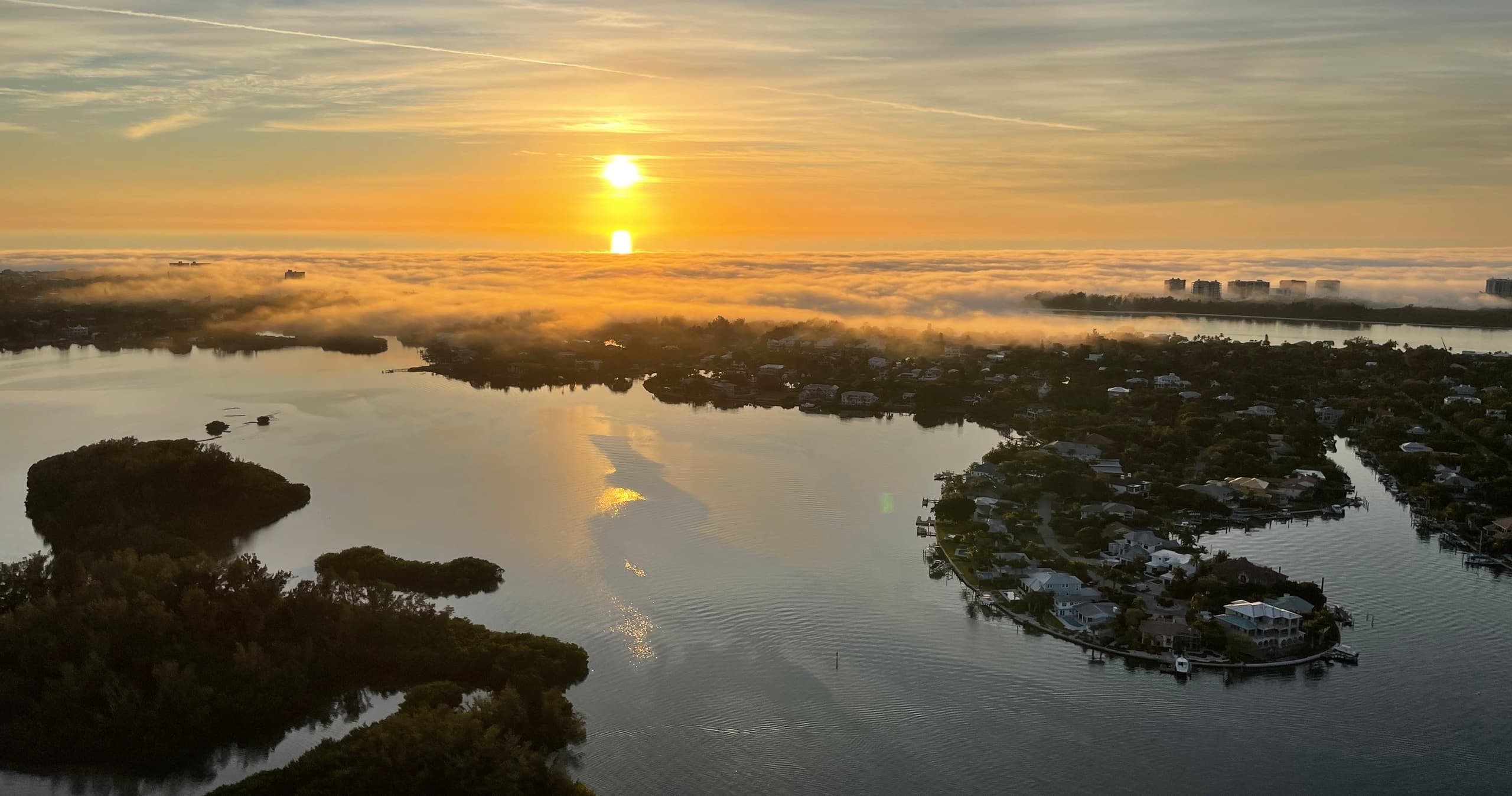 Aerial sunrise over Sarasota marsh and bay, scenic helicopter tour