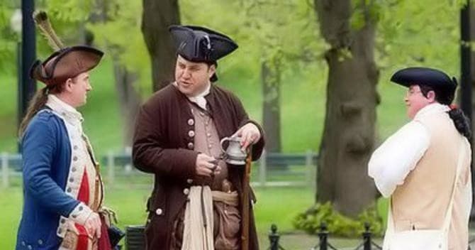 Costumed reenactors conversing outdoors on Freedom Trail walking tour