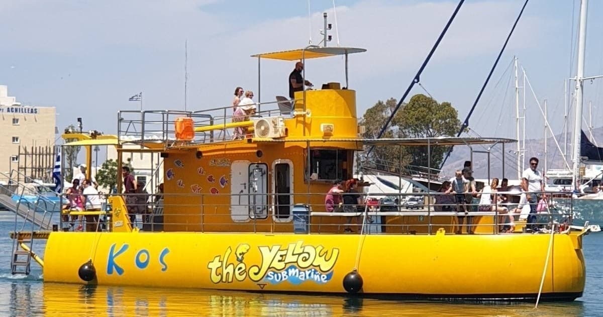 Tourists on bright yellow sightseeing boat in coastal marina