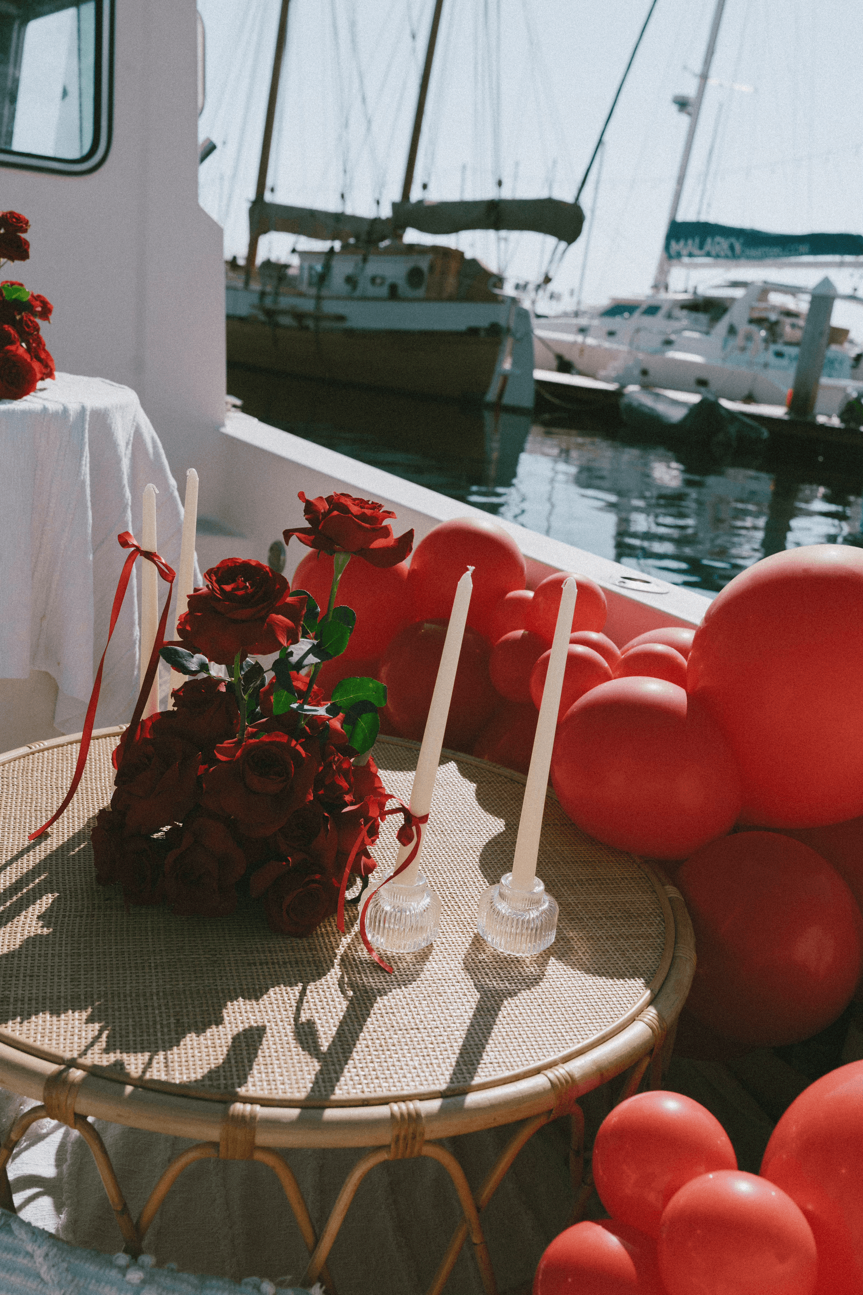 Decorated boat deck with roses and balloons at marina celebration