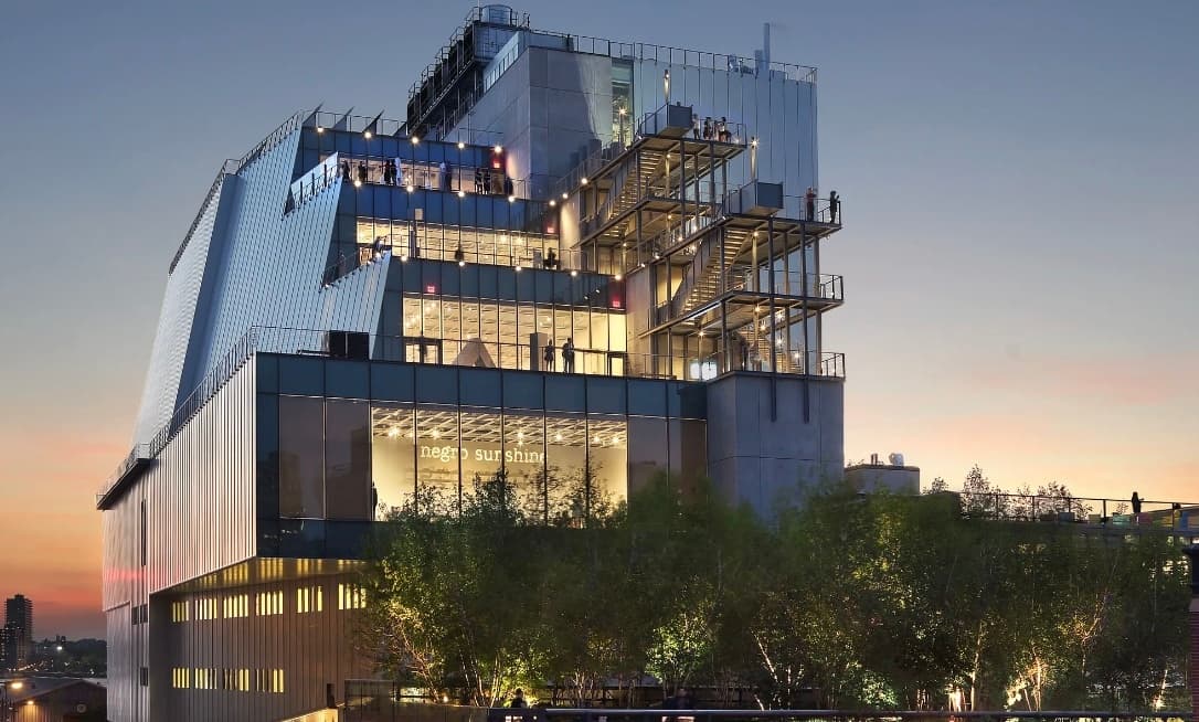 Modern glass museum building at sunset, urban waterfront view