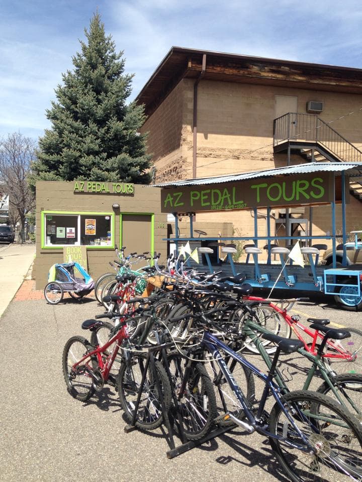 Bicycle fleet lined up outside AZ Pedal Tours shop entrance