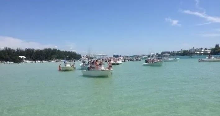 Fleet of leisure boats anchored in clear bay for island hopping