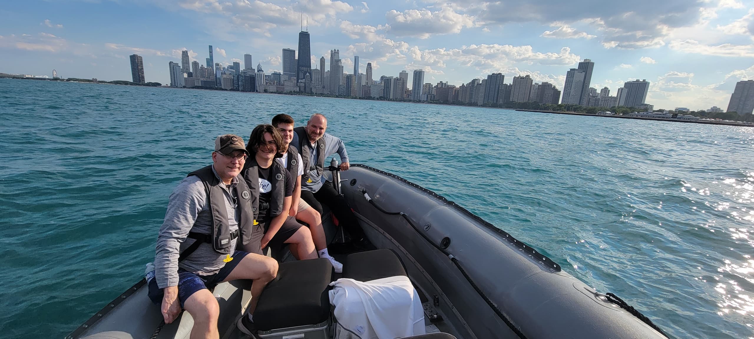 Group on speedboat with Chicago skyline on Lake Michigan