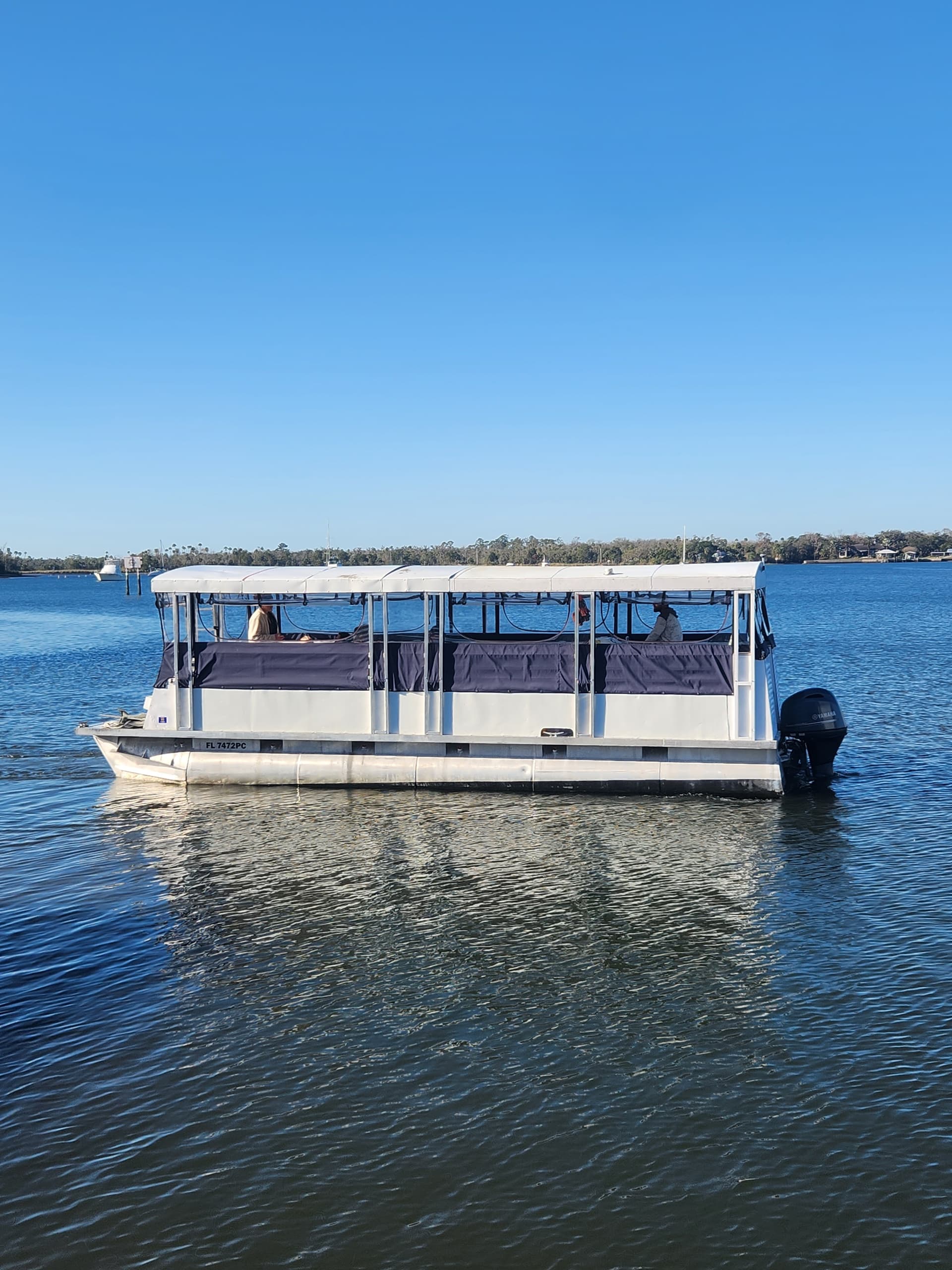 Pontoon boat on calm river or spring, scenic outdoor boat tour
