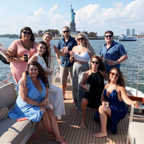 Group enjoying private boat cruise past Statue of Liberty in NYC