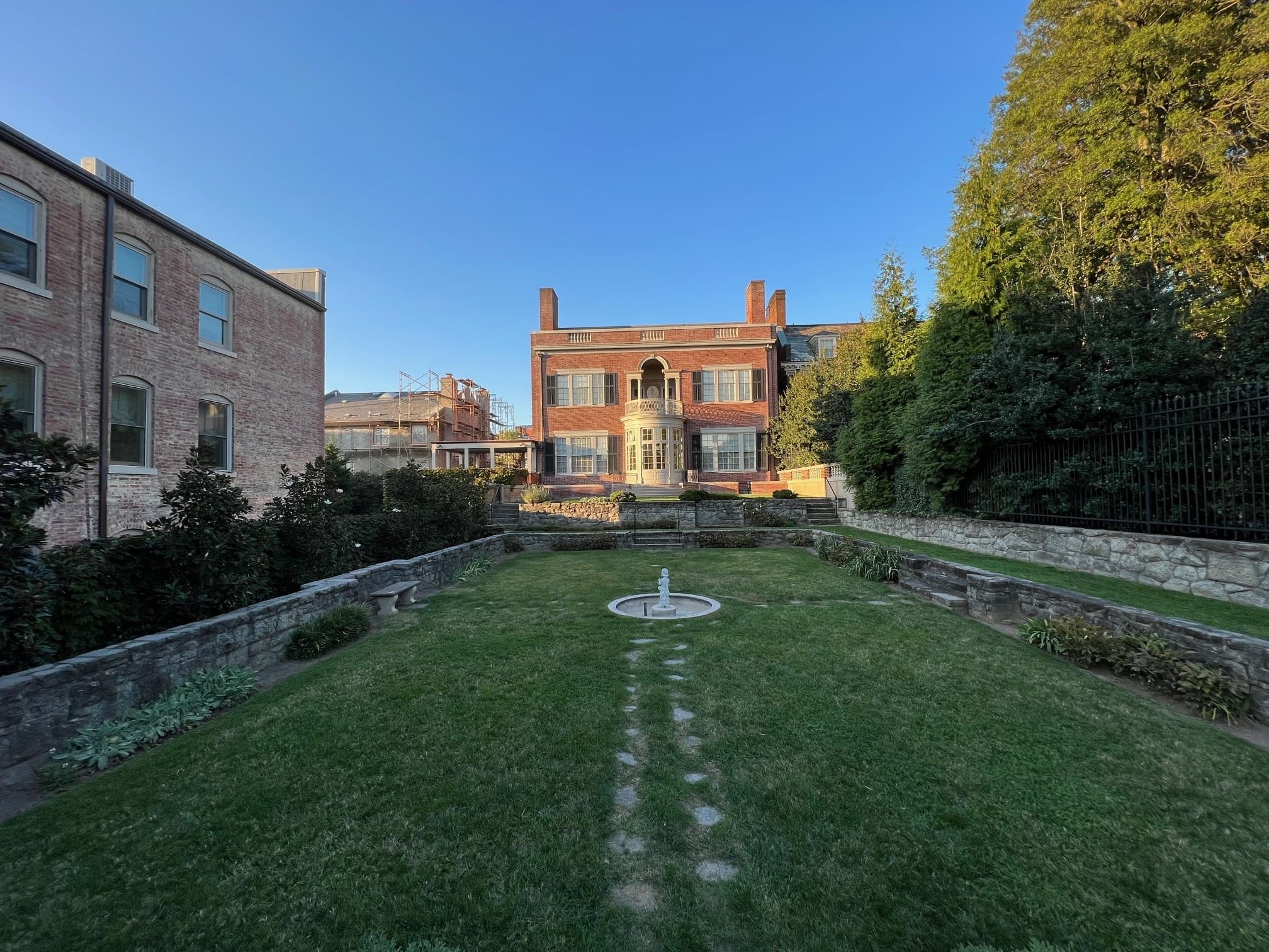 Formal mansion lawn with central fountain at historic house