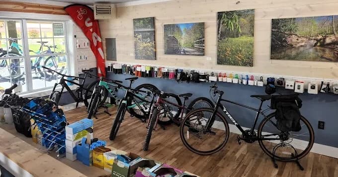 Interior view of bike shop showing touring bikes and gear for rentals