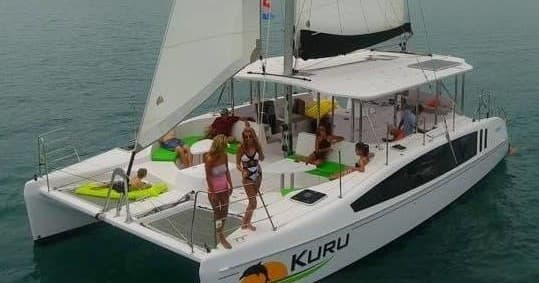 Catamaran sailing with passengers on tropical ocean cruise