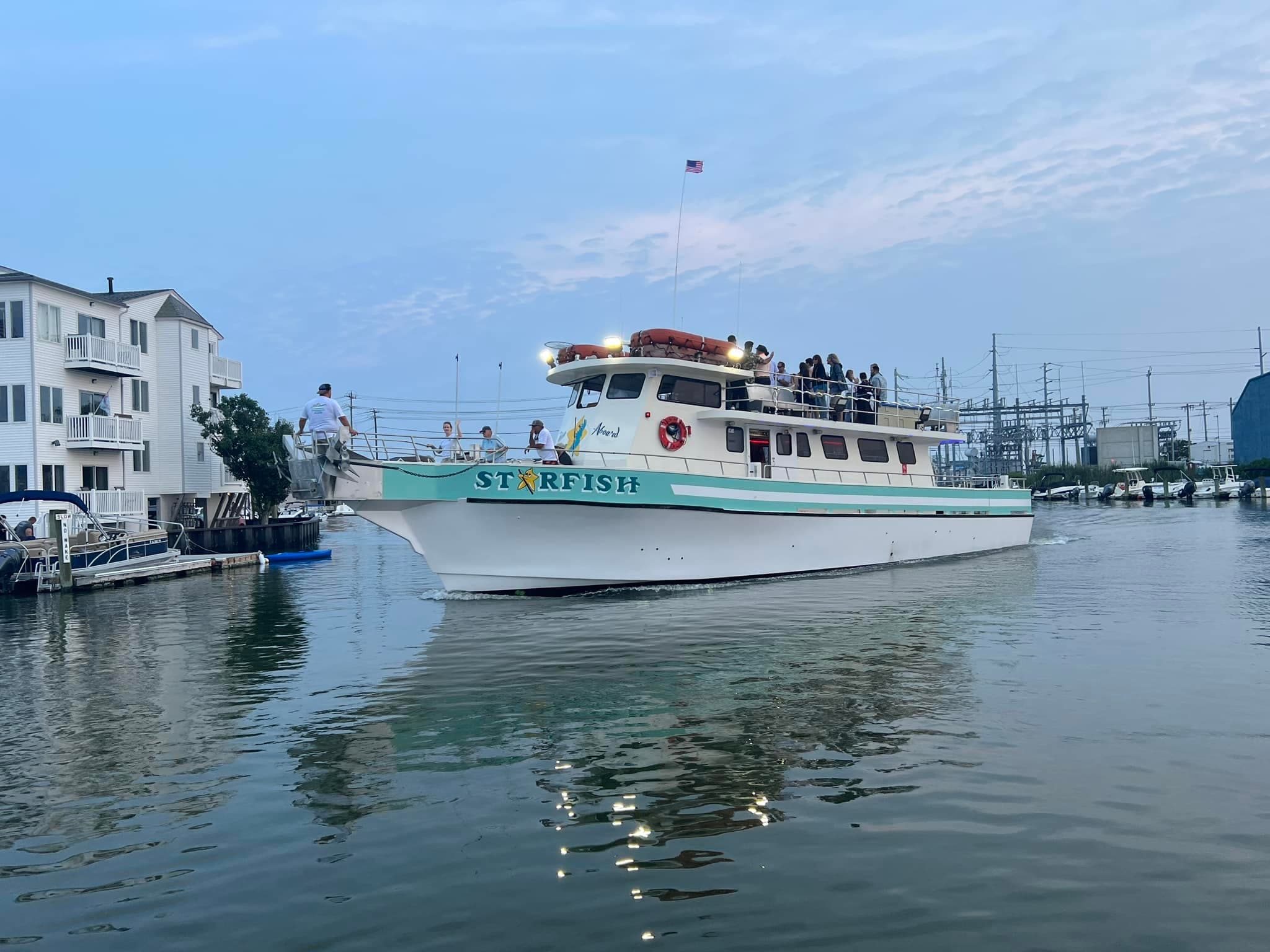 Fishing charter docked in marina with reflective water