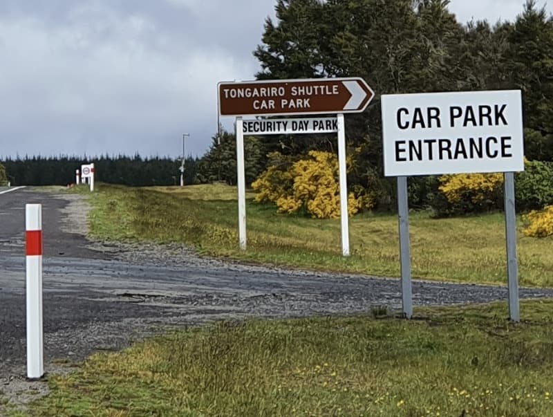 Car park entrance sign at mountain trailhead parking area