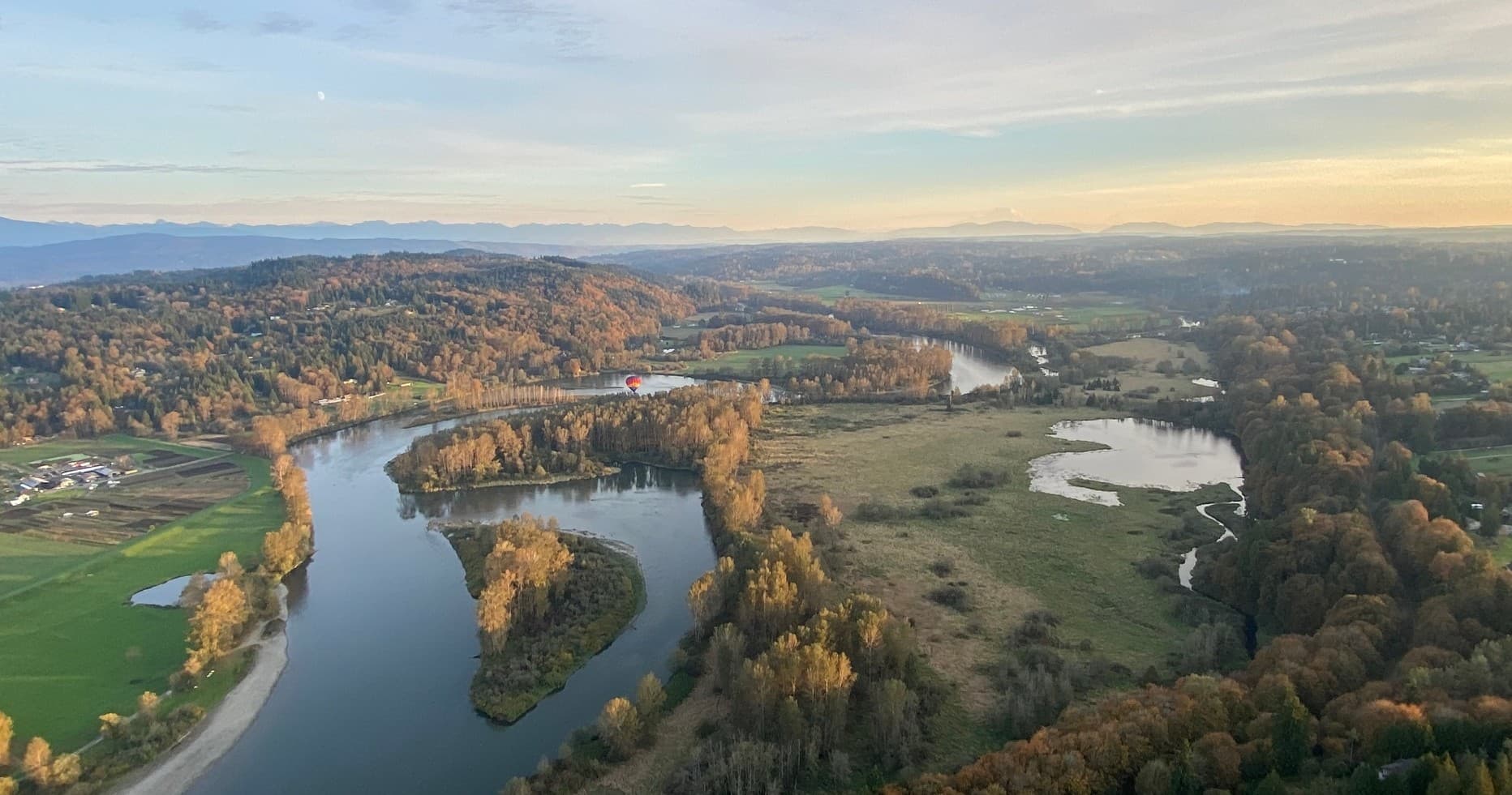 Aerial river valley view from hot air balloon at sunrise