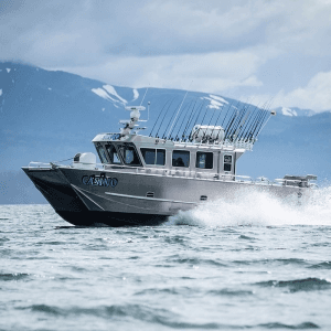 High-speed fishing charter boat breaking waves in Alaska waters