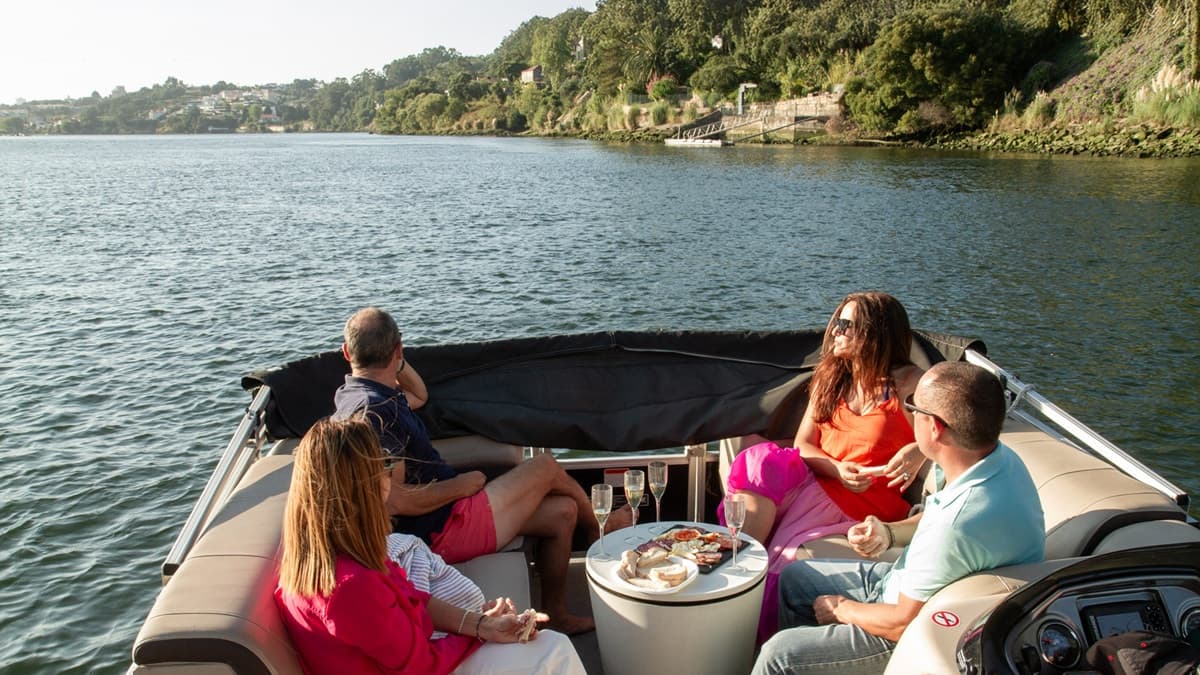 Friends enjoying leisurely cruise with picnic on river