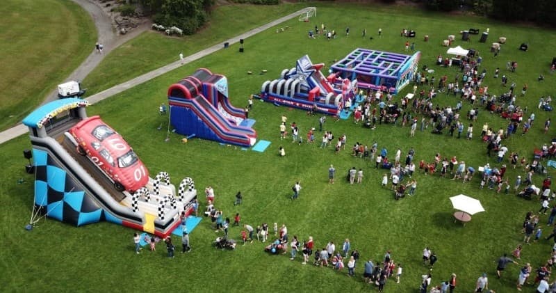 Aerial view of inflatable obstacle course event on field