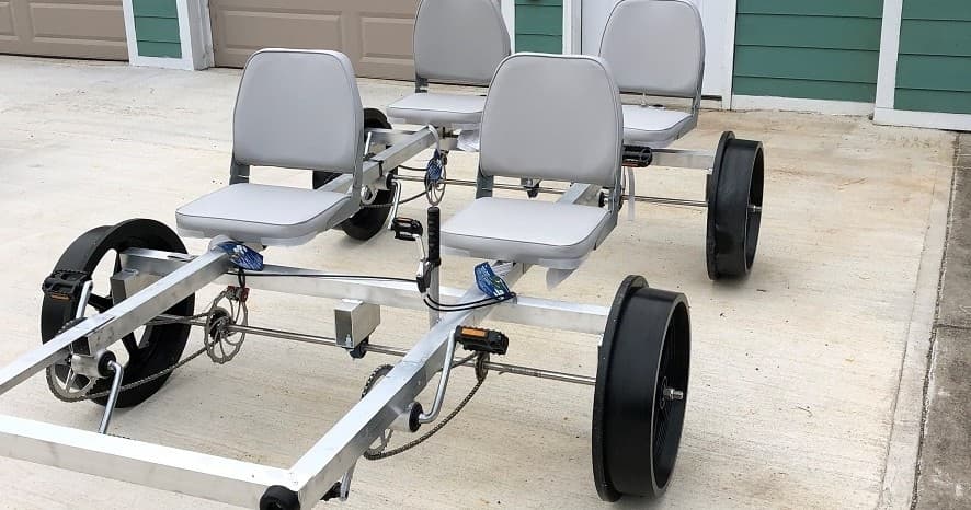 Four-seat railrider cart parked on concrete driveway
