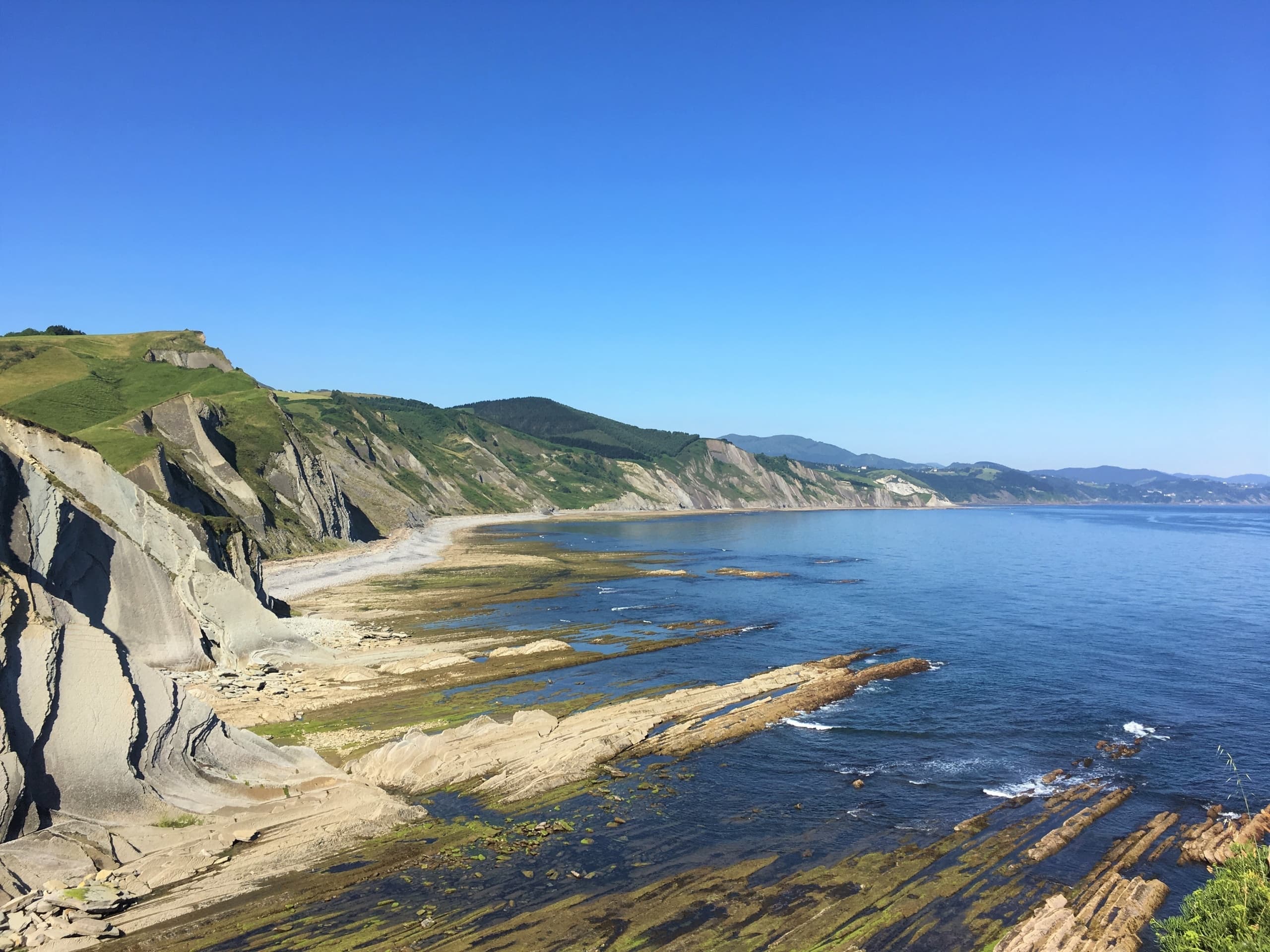 Dramatic rocky coastal cliffs and waves along Basque shore
