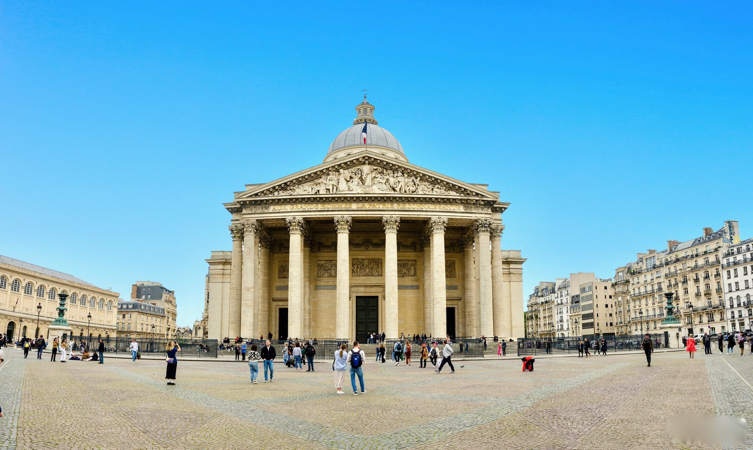 Sightseers at the Pantheon plaza in Paris exploring historic monument