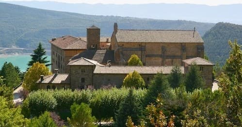 Monastery overlooking rolling hills and a distant lake