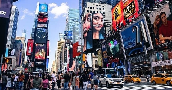 Tourists sightseeing in Times Square Manhattan city street