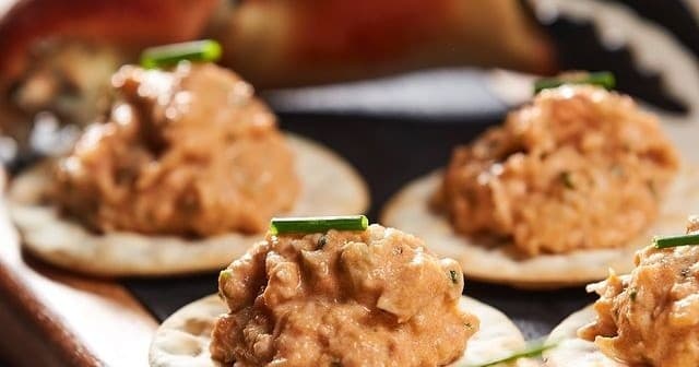 Creamy seafood canapés on crackers for wine tasting pairing