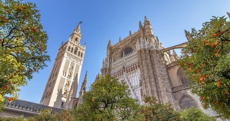 Giralda tower and Seville cathedral under blue sky