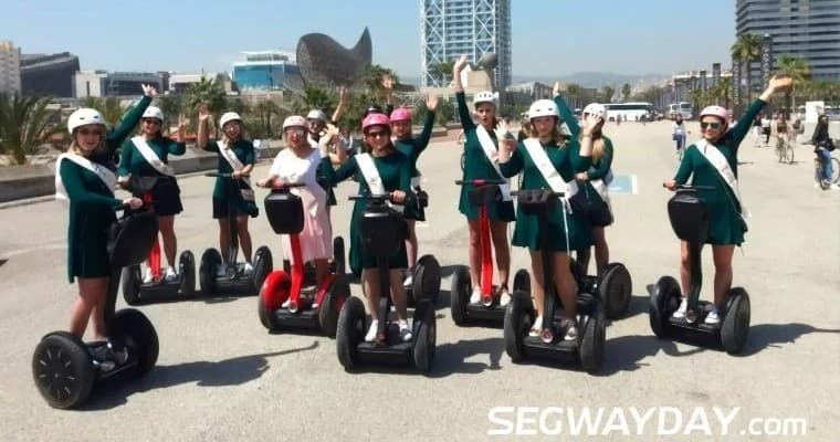 Segway tour group riding along Barcelona beachfront promenade