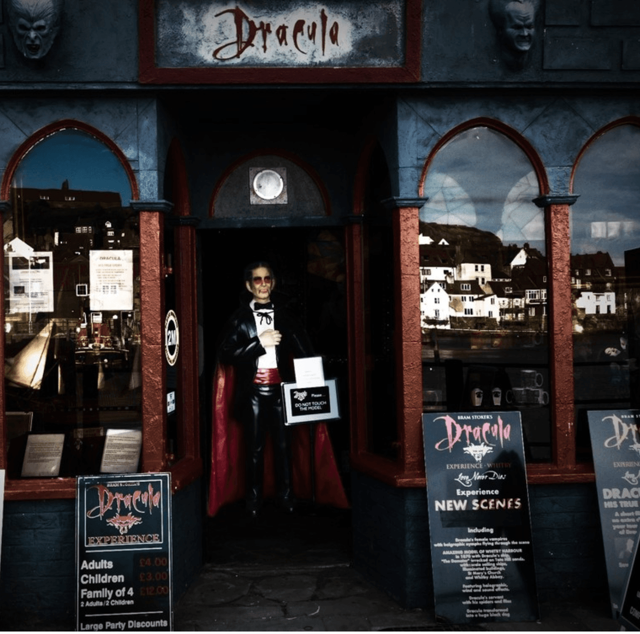 Dark Dracula exhibition doorway in coastal town displaying vampire figure