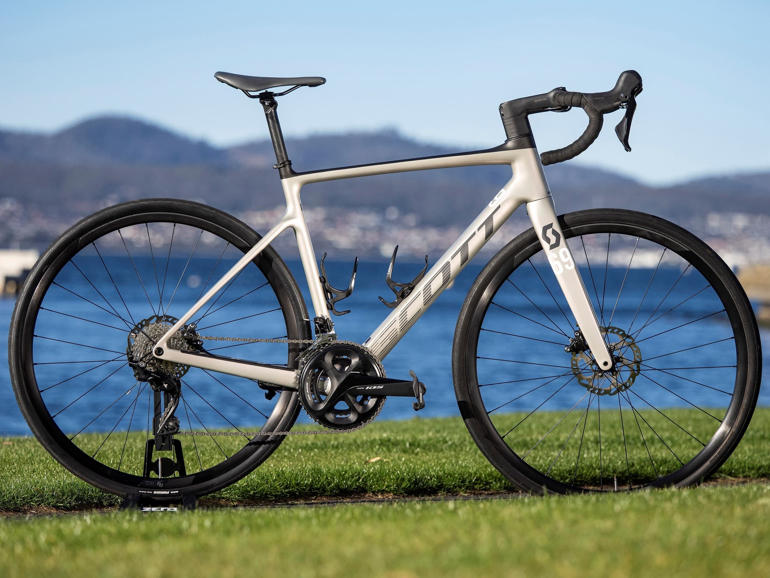 White road racing bike beside scenic Hobart waterfront and bay