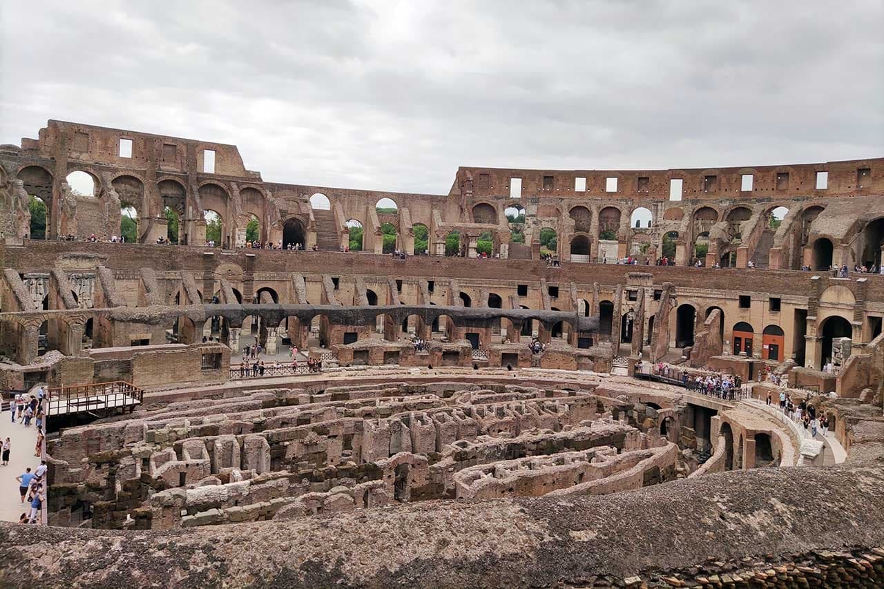 Wide interior view of the Colosseum ruins on Rome walking tour
