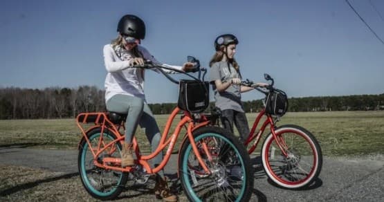 Two riders on electric bikes touring rural Virginia fields