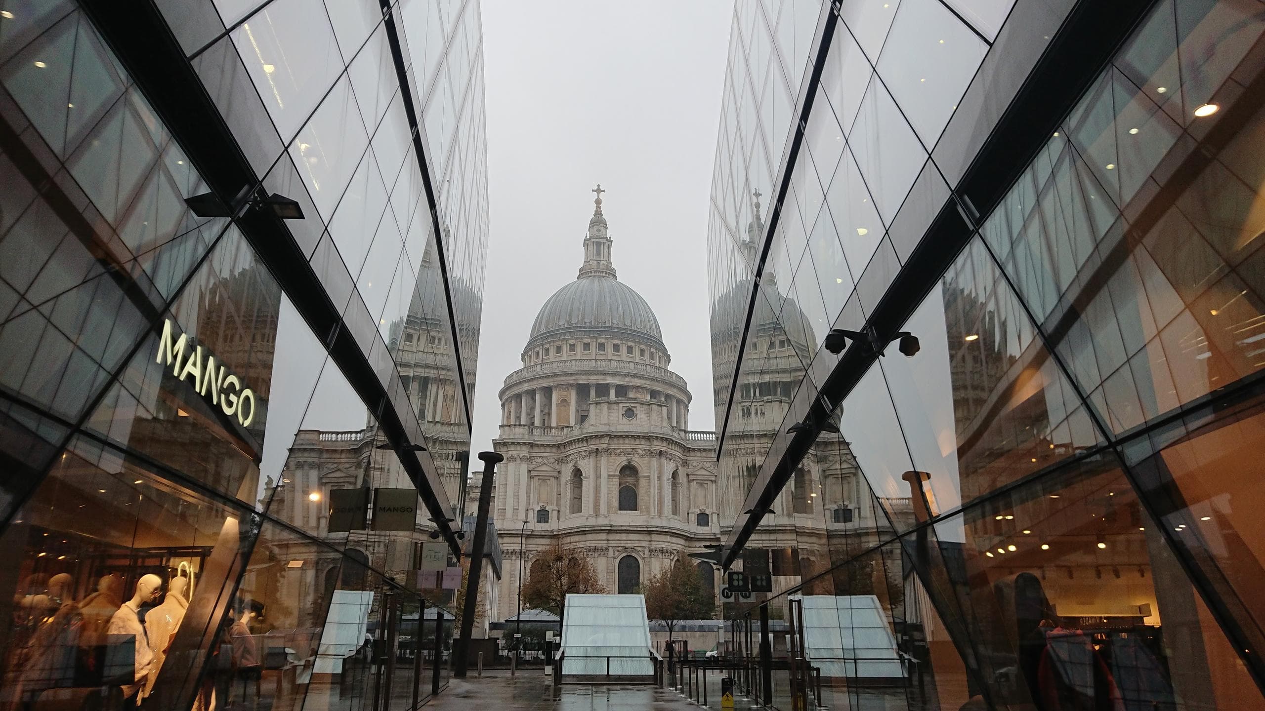St Paul's Cathedral framed by modern glass walkway in London