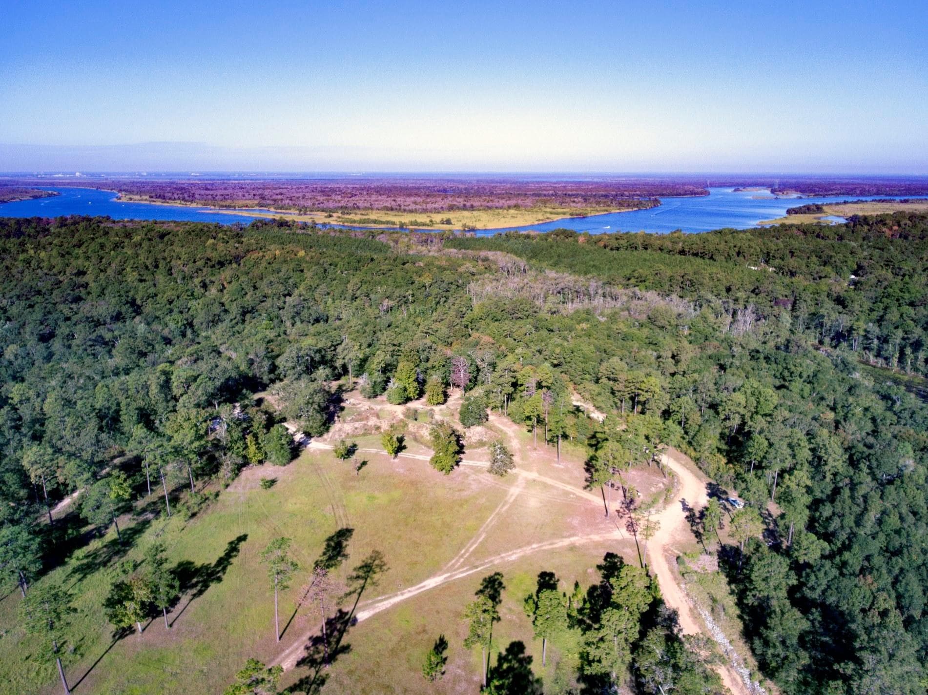 Aerial view of wooded countryside and scenic winding creek